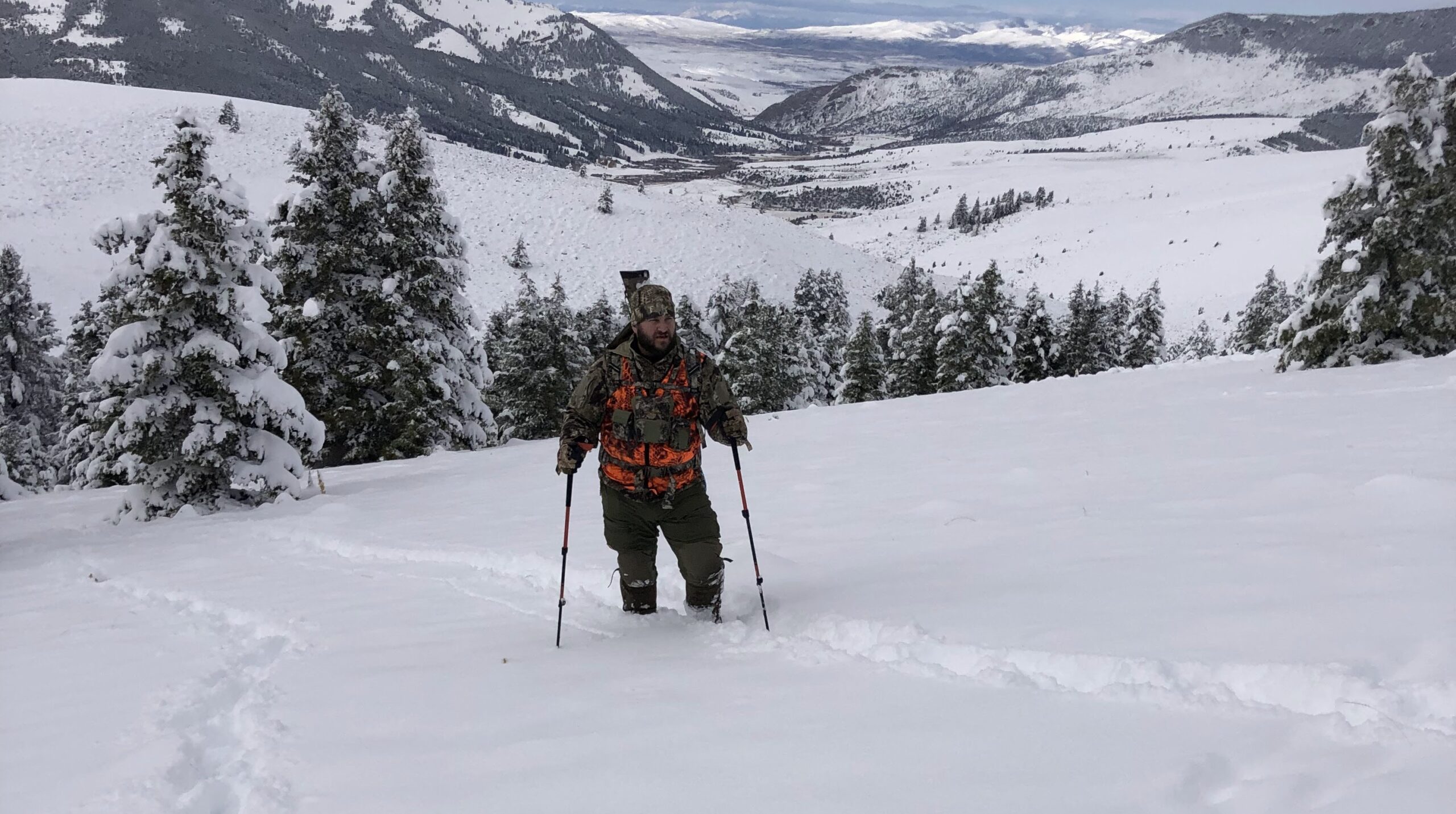 hiking through deep snow with full outdoor gear system in use