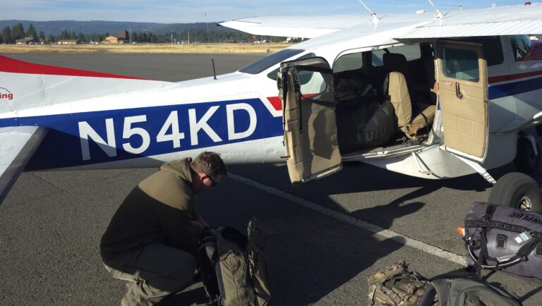 Checking outdoor gear before a remote backcountry flight
