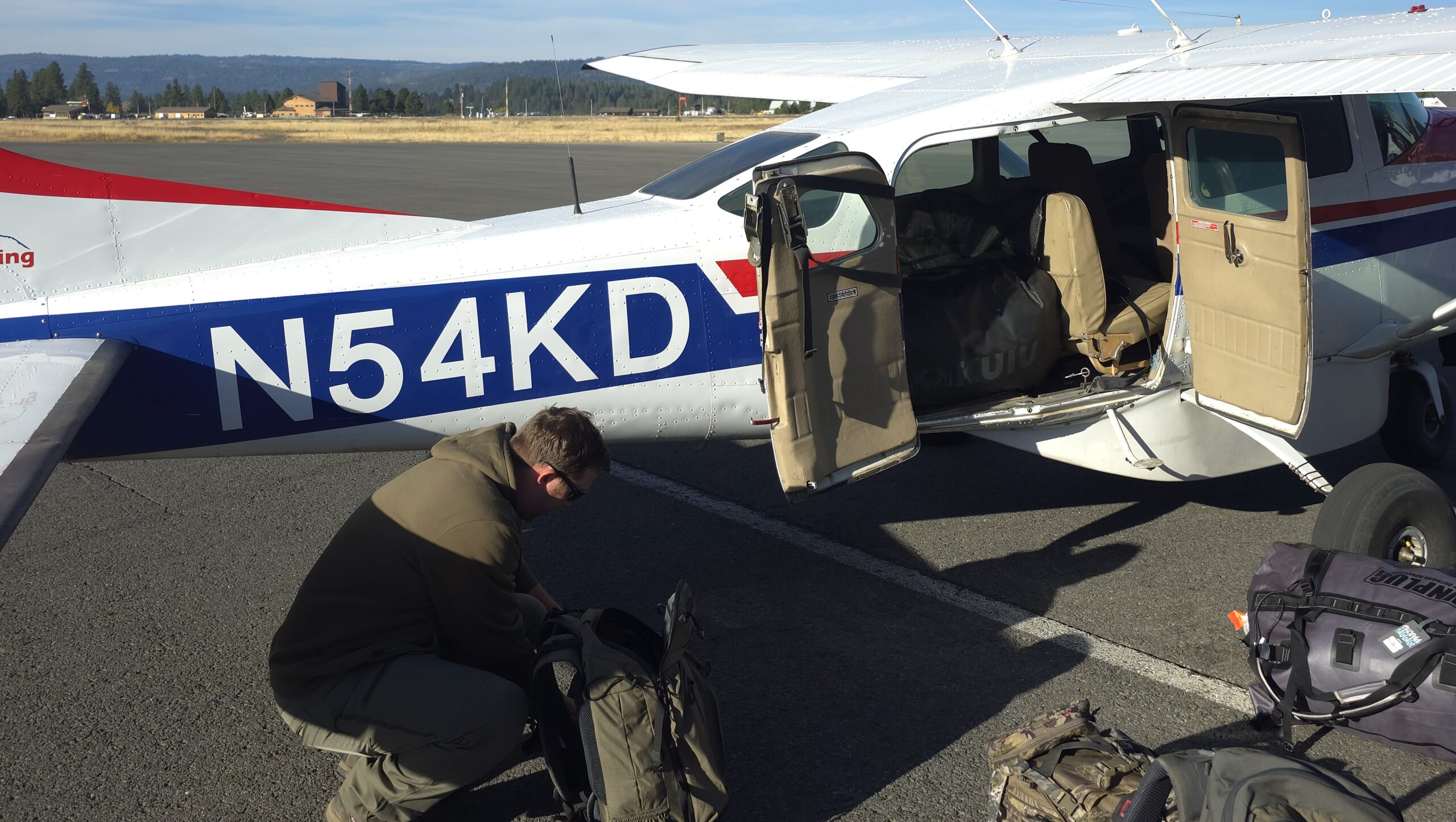 Checking outdoor gear before a remote backcountry flight