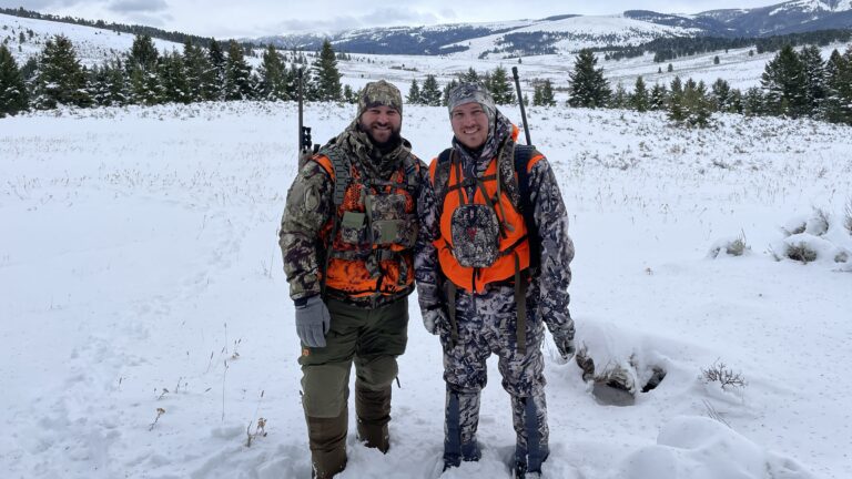 two hunters using different outdoor gear systems in snowy backcountry conditions