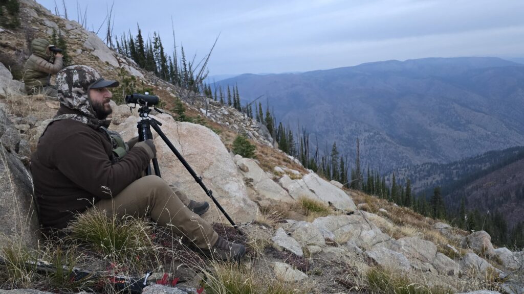hunter glassing on rocky mountainside wearing tan hunting pants