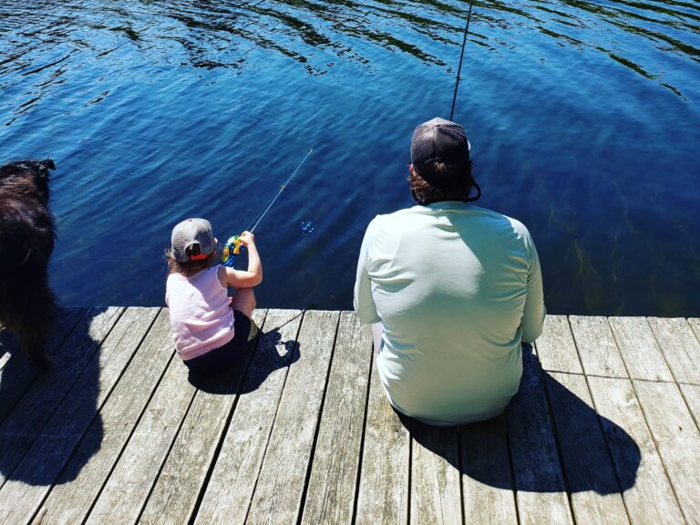 Fishing from a dock on a Northeast lake during a casual bass fishing trip